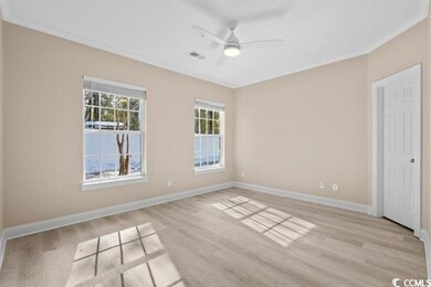 Unfurnished room featuring light wood finished floors, ornamental molding, baseboards, and ceiling fan