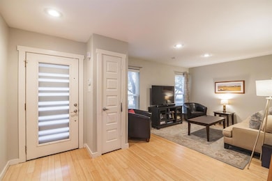 Living area with recessed lighting, light wood-ty