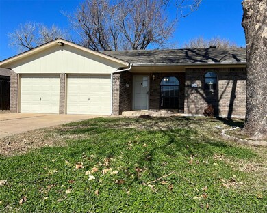 Single story home featuring a front lawn and a gar