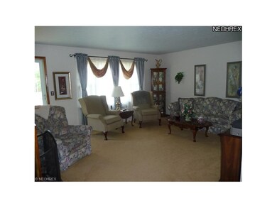 The living room has newer carpeting. There are har