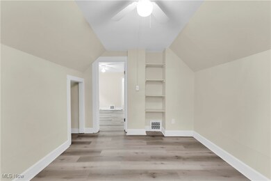 Bonus room featuring ceiling fan, light hardwood / wood-style flooring, and lofted ceiling