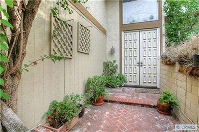 Enter through a charming gated courtyard and dual 