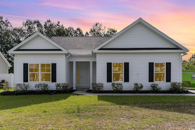 Single story home with a front lawn and roof with 