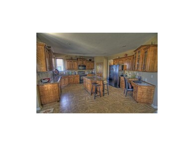 Oversized kitchen with granite counters and tile f