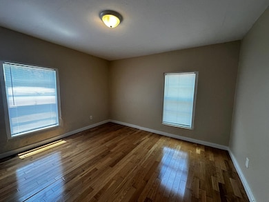 Spare room with hardwood / wood-style flooring an