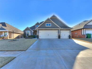 Craftsman-style house with an attached garage, fence, board and batten siding, and driveway