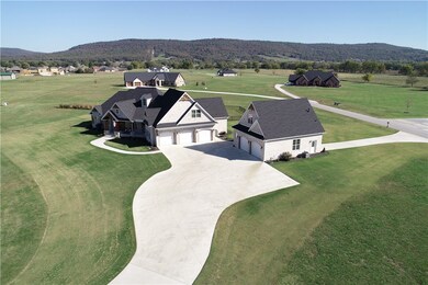 Note that the shop/garage is a drive-through structure with a rear garage door providing access from the street behind the house. Check out that fantastic view behind the house!