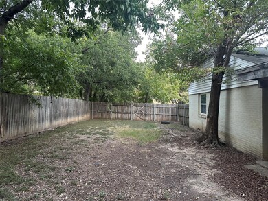 Mature trees in backyard along with a covered porc