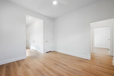Empty room with a ceiling fan, baseboards, and lig