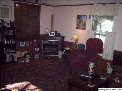 Living room with gas log fireplace.