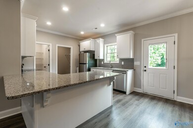White cabinets, stainless appliances, granite coun