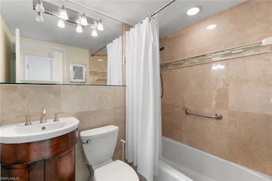 Full bathroom with vanity, decorative backsplash, 