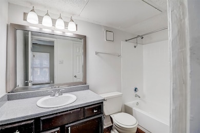 Full bathroom featuring vanity, toilet, shower / b