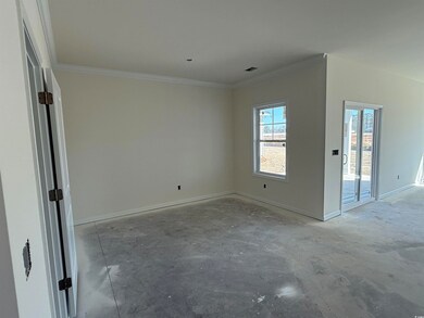 Spare room with visible vents, baseboards, and orn
