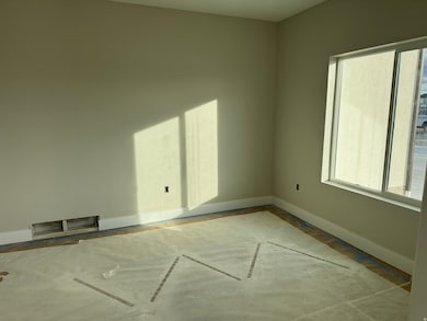 Unfurnished room with baseboards