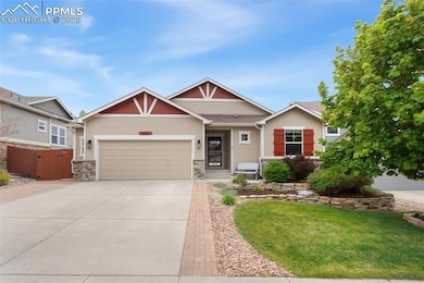 Craftsman-style home featuring concrete driveway, stone siding, and an attached garage