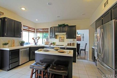 Large open kitchen has Dark Cabinetry, Recessed li