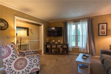 Very cute family room with a lot of nice natural light, right off the front door entryway.