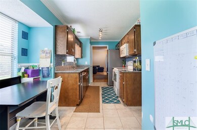 Breakfast nook and kitchen, with media room beyond