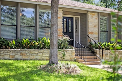 Doorway to property featuring stone siding and ro
