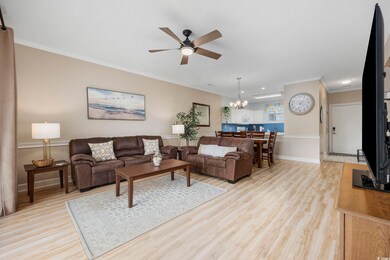 Living room with ornamental molding, light hardwoo