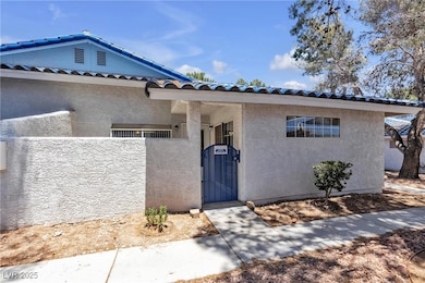View of front of home featuring a gate, stucco sid