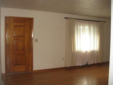 A view of the living room and front entrance from 
