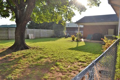 Fenced in back yard with covered patio