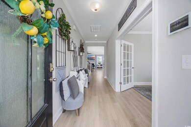 Interior space with crown molding and light hardwo