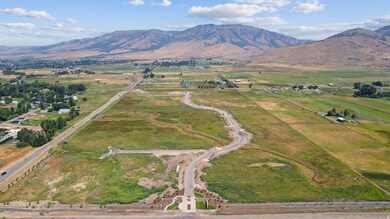 Aerial overview of property's location with a mountainous background and rural landscape