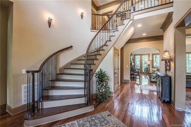 Grand curved staircase and 2-story foyer greets gu
