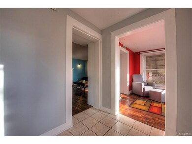 Foyer opens to living and sunroom.