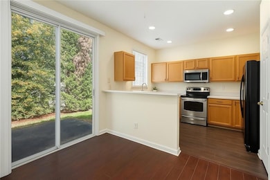 Kitchen with recessed lighting, dark wood-style fl