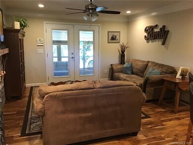 DEN WITH FIREPLACE OPENS TO KITCHEN AND SUNROOM.
