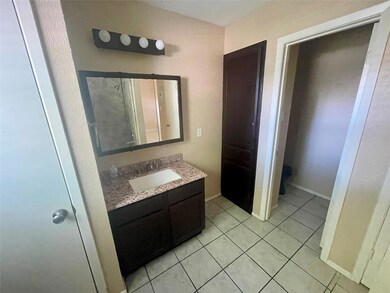 Full bath with vanity, tile patterned flooring, b