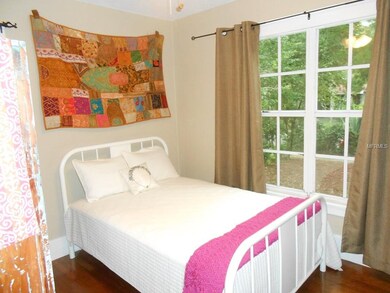 One of two bedrooms with hardwood floors and over-sized newer windows.