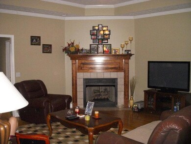 A great large family room with fireplace, trey ceilings and oak hardwood flooring