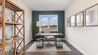 Office space featuring dark hardwood / wood-style 