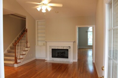 Den with open staircase to bonus room  plus doorway to Living room