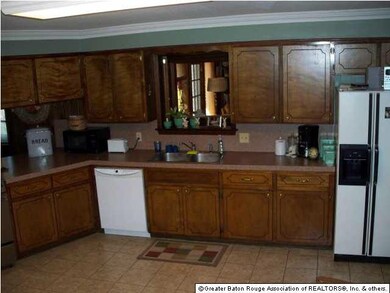 Large open kitchen has HUGE breakfast bar