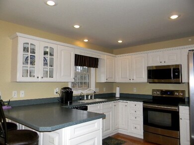 White cabinets, solid surface counter tops.