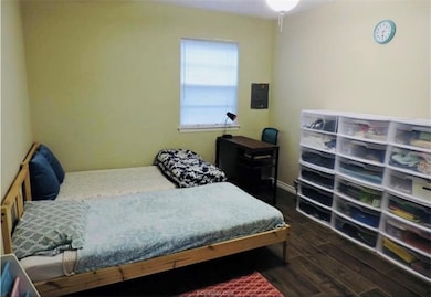 Bedroom featuring dark wood finished floors
