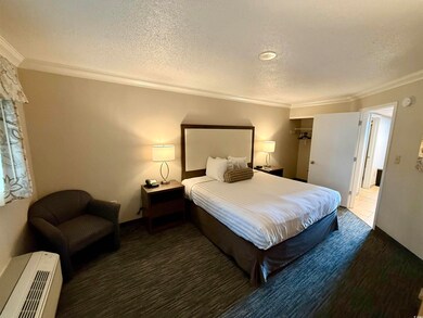 Bedroom featuring a textured ceiling and ornamenta