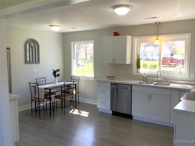 Kitchen featuring light countertops, a sink, stain