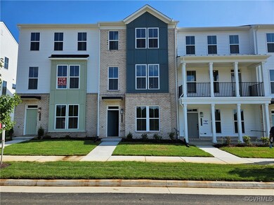 View of property with a front yard, a balcony, a p