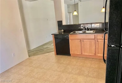 Kitchen featuring black appliances, dark counterto