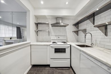 Efficient kitchen has marble counter, subway tile