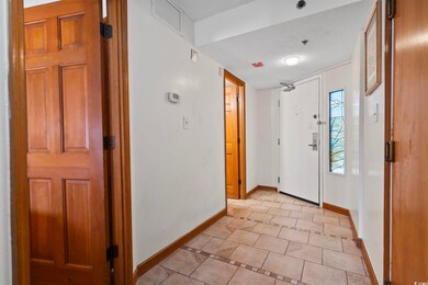 Tiled foyer with a textured ceiling