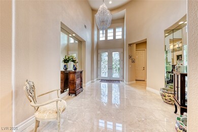 Foyer entrance featuring marble finish floor, a hi
