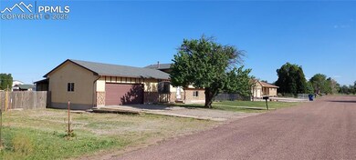 View of front of home featuring a garage, driveway, and brick siding